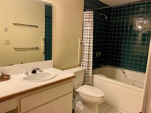 A bathroom with a white sink, mirror, toilet, and bathtub. - 1BR + 2 Full Baths Sleeps 6 - Wooded View Balcony, Indoor Pool, Rivergreen (Lincoln)