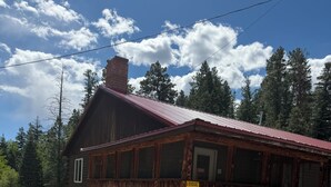A rustic lodge with a red roof, wooden exterior, and a sign indicating it is a lodge parking area.