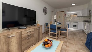 A modern kitchen with white cabinets, a built-in oven, and a microwave. - Castle Harbour 41 - One Bed (Los Cristianos)