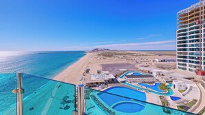 Een resort met een zwembad, strand en uitzicht op de oceaan.