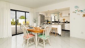 A modern kitchen with white cabinets, a marble countertop, and pendant lighting. - Villa for 7 people with private Picuzzi in Punta Cana. Close to everything! (Punta Cana)