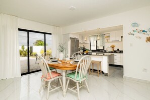 A modern kitchen with white cabinets, a marble countertop, and pendant lighting. - Villa for 7 people with private Picuzzi in Punta Cana. Close to everything! (Punta Cana)