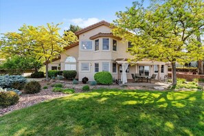 A two-story house with a patio and a covered outdoor seating area. - #HabitueHomes - The Quail Ridge Overlook (Boise)