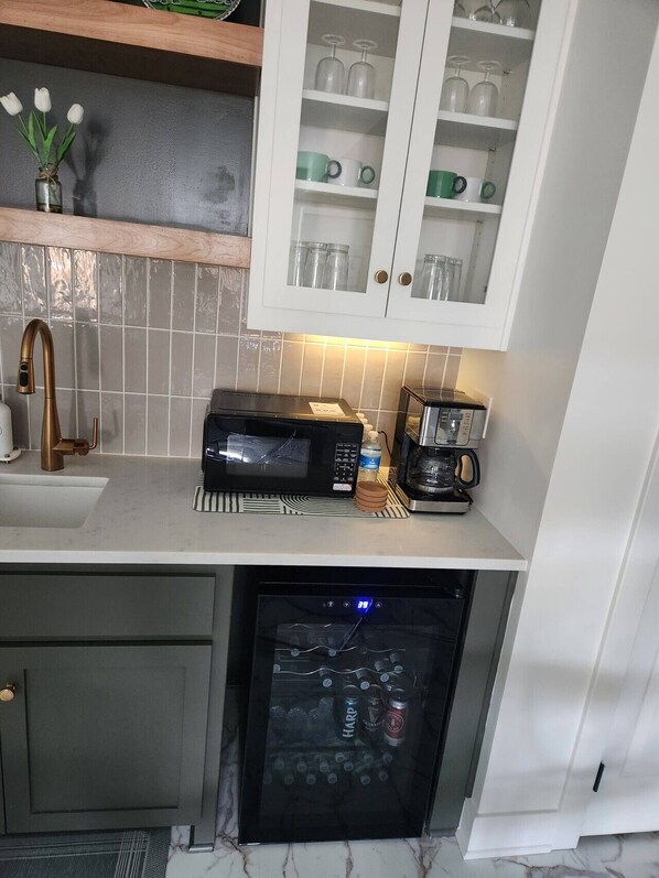Eine Küche mit Mikrowelle, Kaffeemaschine und Geschirrspüler.