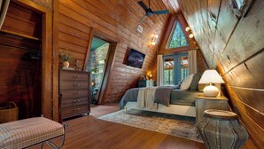 Un dormitorio acogedor con cama, cómoda, banco y un jarrón decorativo.