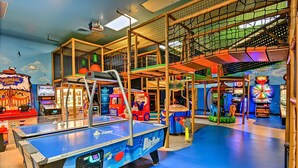A multi-level indoor play area with various arcade games, a ping pong table, and a Ferris wheel. - Spacious Townhome Near Disney, Free Parking (Davenport)