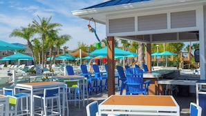 An outdoor pool area with lounge chairs, umbrellas, and a covered seating area. - Luxury 5BR House Private Pool & BBQ Sleeps 18 (Davenport)