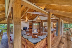 Ein Holzinterieur mit einer Couch, einem Fernseher und einem Essbereich.