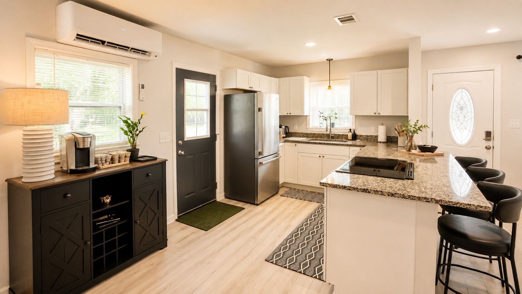 A modern kitchen with a central island, built-in appliances, and a dining area with bar stools.