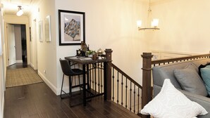 A hallway with a staircase, a dining area with a table and chairs, and a sofa with pillows. - Fabulous 5-bedroom house with AC in charming Chickamauga (Chickamauga)