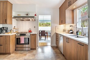 Cozinha moderna com armários de madeira, forno Bosch e vista para o exterior.