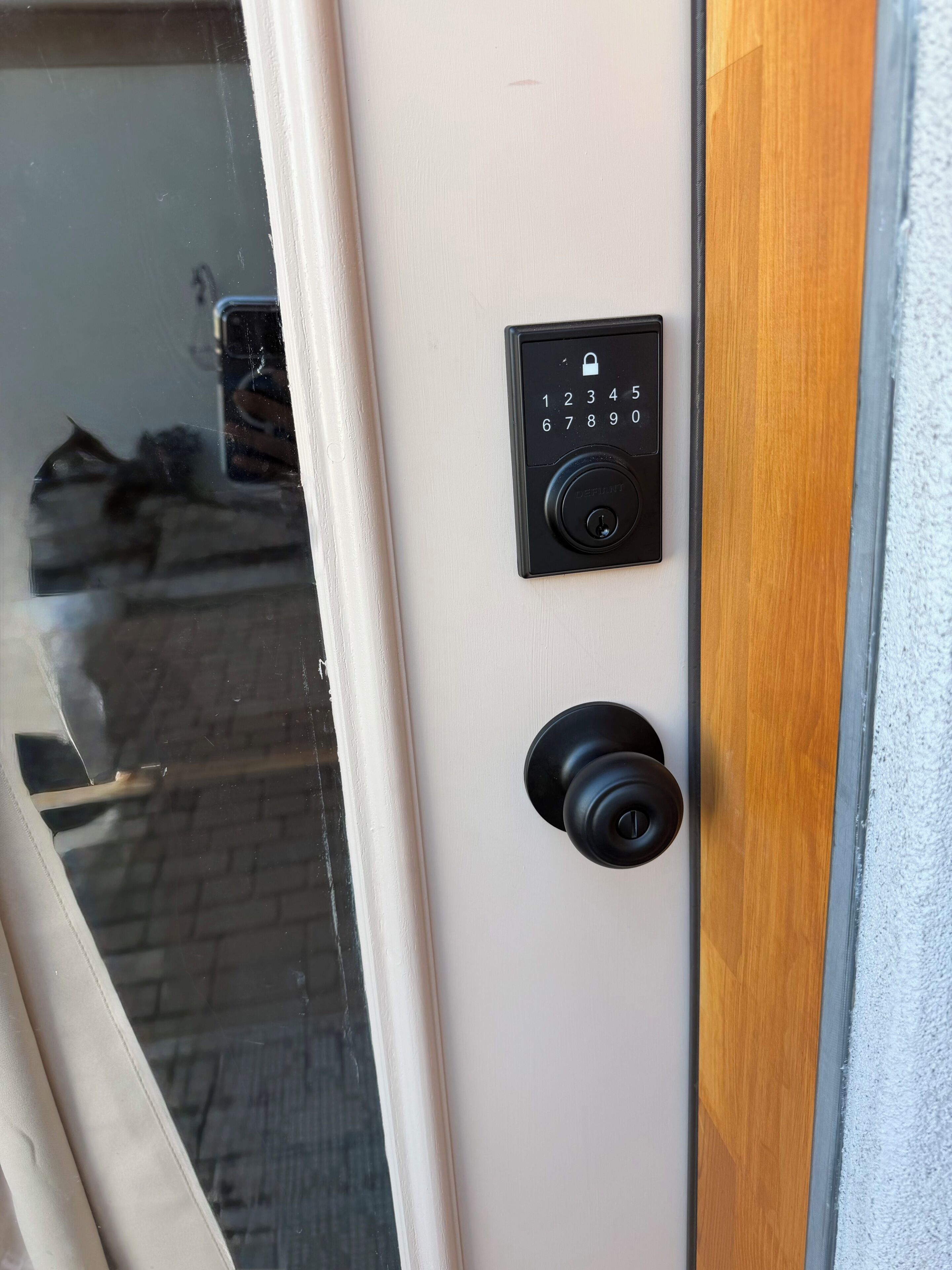 A door with a keypad lock and a keyhole.