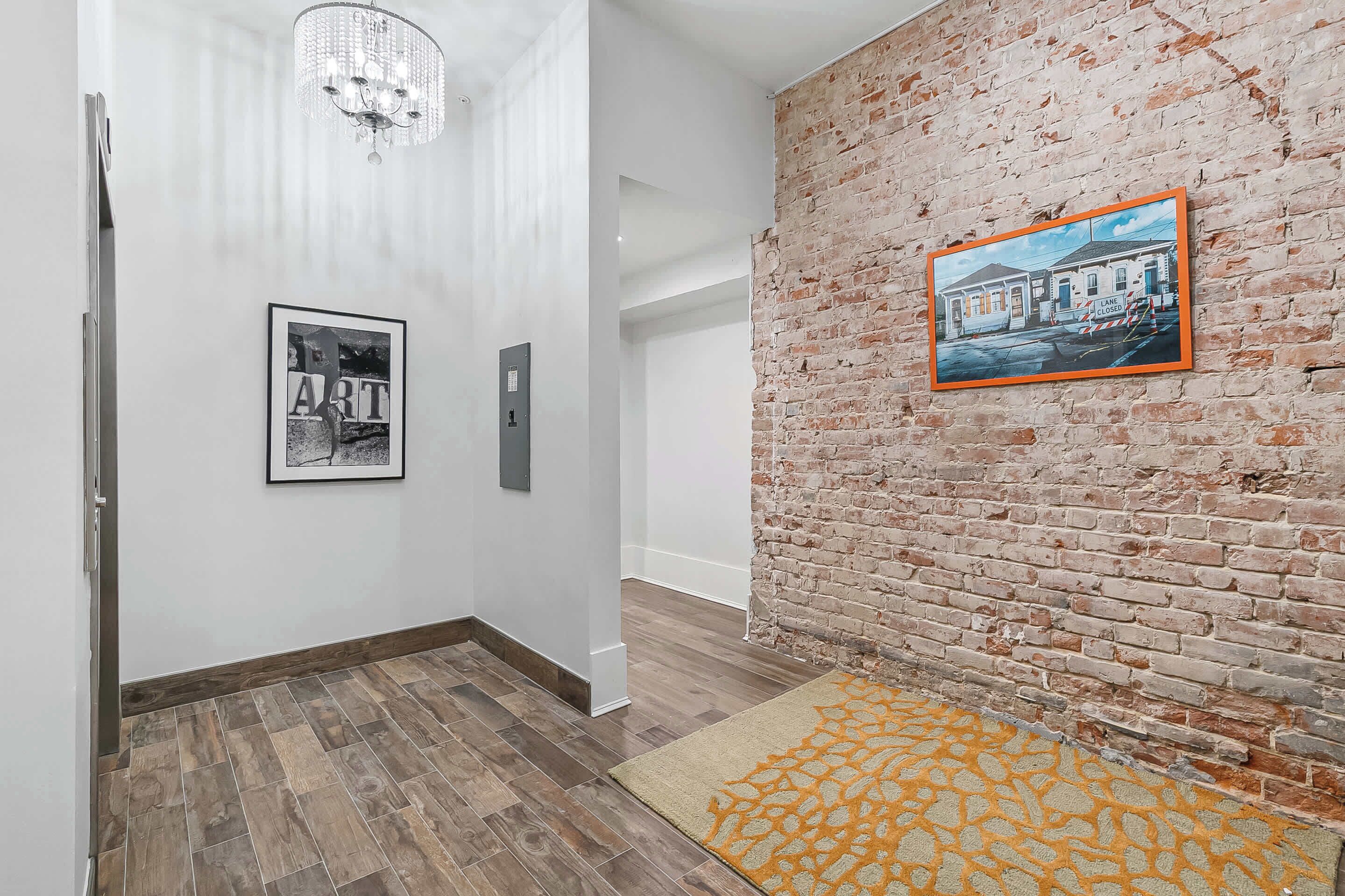 Convenient elevator access featuring Jessie Marie artwork and iconic Herb Leonard photography celebrating New Orleans music and culture.
