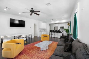 Funk Room featuring walls decorated with bold local artwork, cozy lounge seating, soaring ceilings, and vibrant New Orleans-inspired style. - Lux  Funk Suite W/2  Luxury Baths (Top Floor) (New Orleans)
