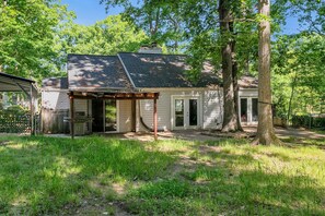 A single-story house with a covered patio, a garage, and a large tree in front. - Renovated Pet-friendly 3br 2.5ba Fenced House in Charming Mauldin and EV Charger (Mauldin)