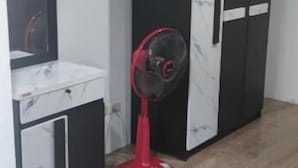 A room with a white cabinet, a red fan, and a black and white wardrobe. - Old Town (Pattaya)