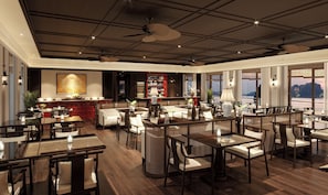 Un amplio vestíbulo de hotel con zona de bar, asientos y grandes ventanales con vistas.