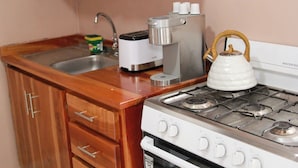 A kitchen with a sink, a toaster, a kettle, and a stove. - Your stay 5 min from Santa Ana Cathedral (Santa Ana)