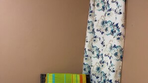 A corner of a room with a wicker chair, a floral curtain, and tiled flooring. - Your stay 5 min from Santa Ana Cathedral (Santa Ana)