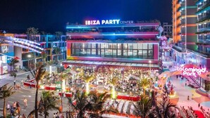 A large building with a sign reading 'IBIZA PARTY CENTER' and a crowd gathered outside. - Flamingo Hai Tien Beach Resort (Hoang Tien)