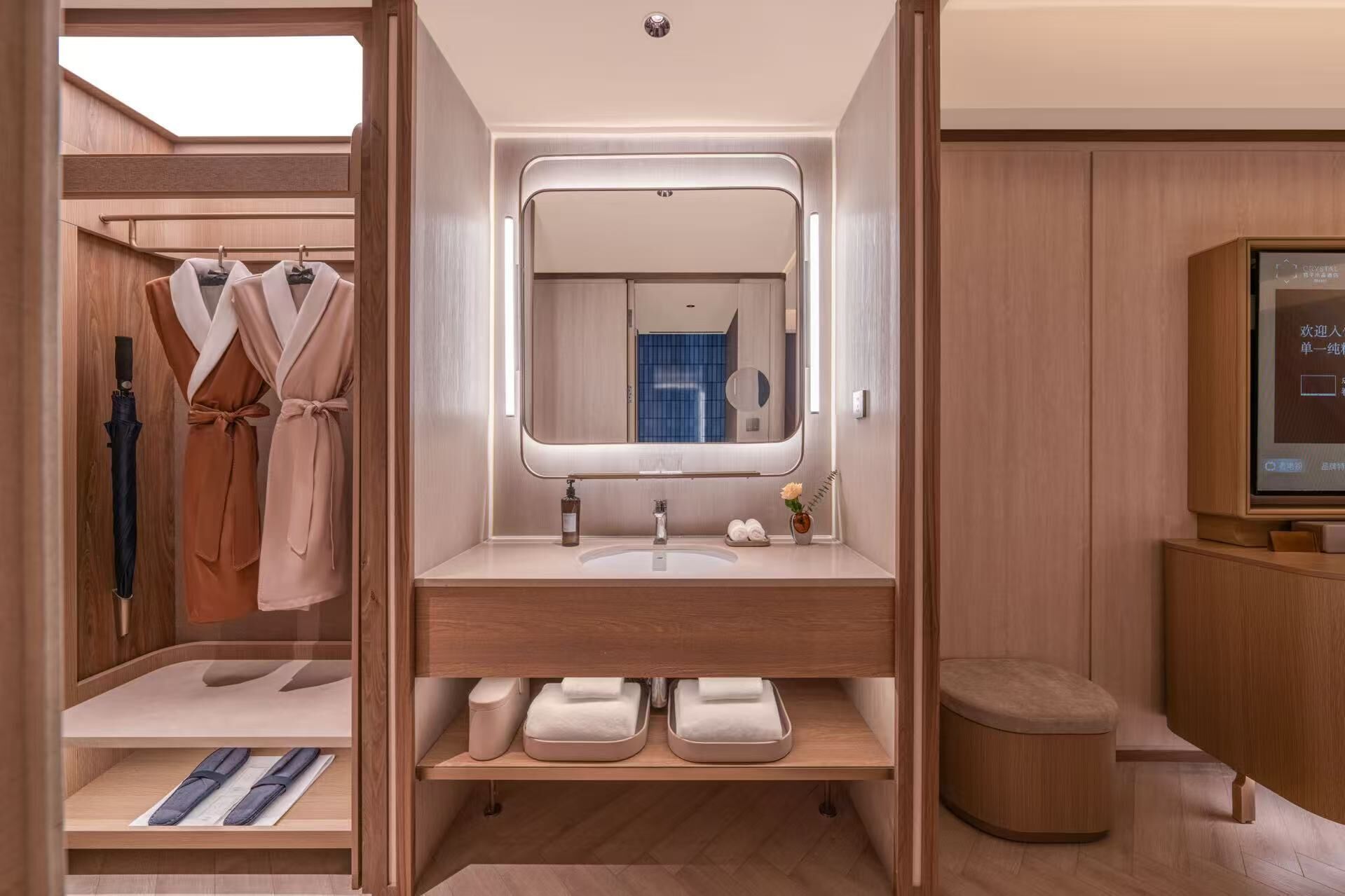 A modern bathroom with a vanity, mirror, and a shower area.