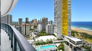 A high-rise hotel with a pool, surrounded by other buildings and a beach. - Ocean Breeze at Oracle Level 21 (Gold Coast)