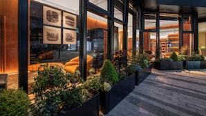A modern hotel lobby with large windows, indoor plants, and seating areas. - IntercityHotel Taikoo Li Chunxi Rd (Chengdu)
