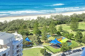A hotel with a pool, a beach view, and a parking area. - Ocean Perfection at Oracle Level 23 (Gold Coast City)