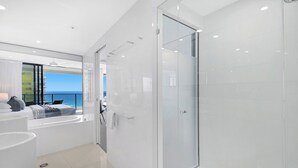 A modern bathroom with a glass shower, a bathtub, and a view of the ocean. - Ocean Perfection at Oracle Level 23 (Gold Coast City)