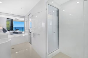 A modern bathroom with a glass shower, a bathtub, and a view of the ocean. - Ocean Perfection at Oracle Level 23 (Gold Coast City)