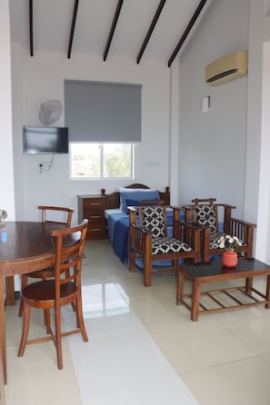 A room with a bed, a desk, a chair, a dining table, and a window. - The Kumatha Residence,Second Floor Studio apartment, 5 minutes walk to the beach (Negombo)