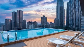 Seasonal outdoor pool, open 5:00 PM to 10:30 PM, pool umbrellas