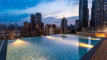 Seasonal outdoor pool, open 5:00 PM to 10:30 PM, pool umbrellas