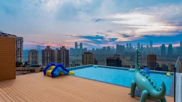 Seasonal outdoor pool, open 5:00 PM to 10:30 PM, pool umbrellas