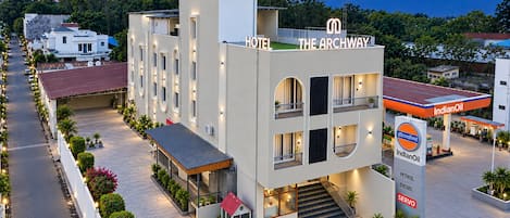 A hotel with a modern design, featuring a two-story structure, a covered entrance, and a visible staircase leading to the entrance.