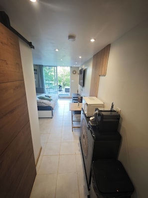 A modern room with a bed, a desk, a TV, and a large window. - Nature break in green Provence (Artigues)