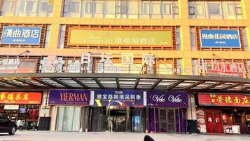 A multi-story building with various commercial establishments on the ground floor, including hotels and restaurants.