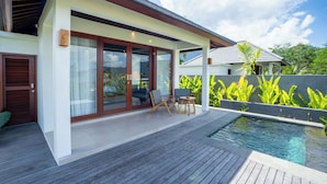 A modern house with a swimming pool, wooden deck, and outdoor seating. - Gauri Villas Sidemen (Sidemen)