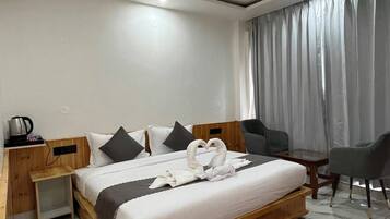 A modern hotel room with a wooden bed, a desk, a chair, and a large window with curtains.