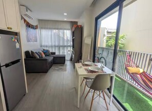 TV, books - Bright Corner Condo - Rooftop Pool with Sea Views (Chalong)
