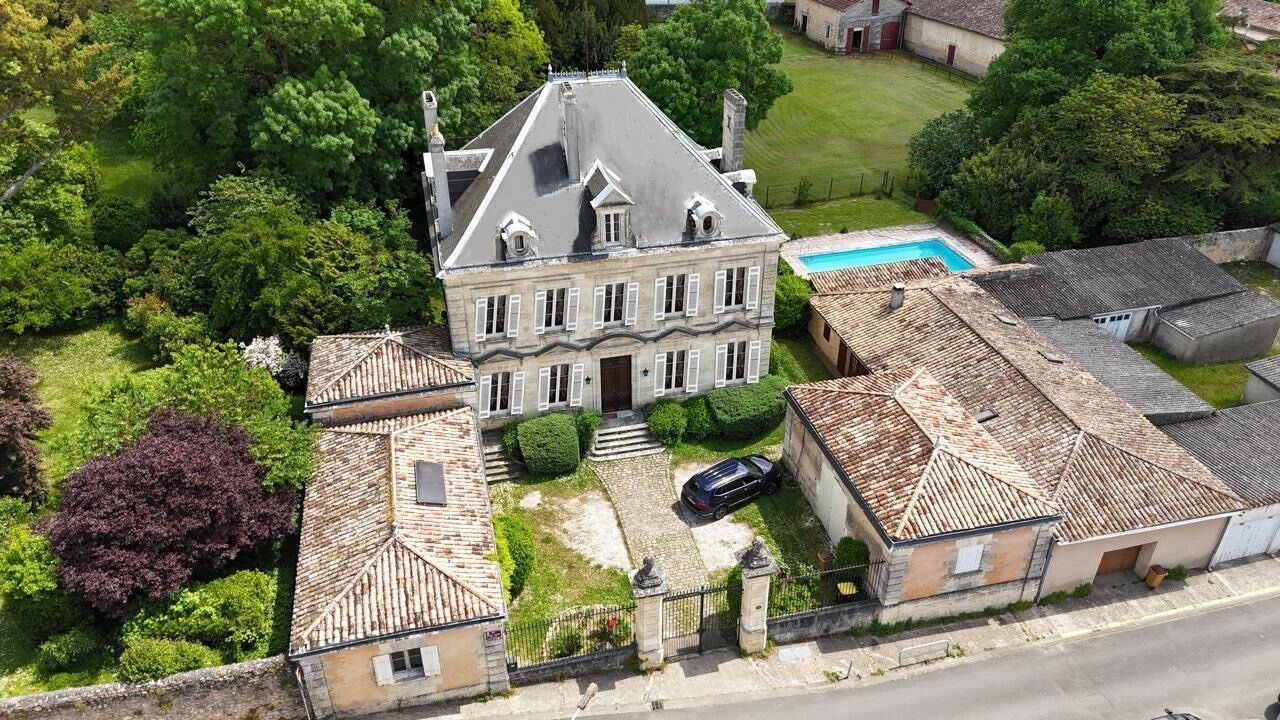 Un vaste domaine comprenant une maison principale, une piscine et plusieurs bâtiments plus petits.