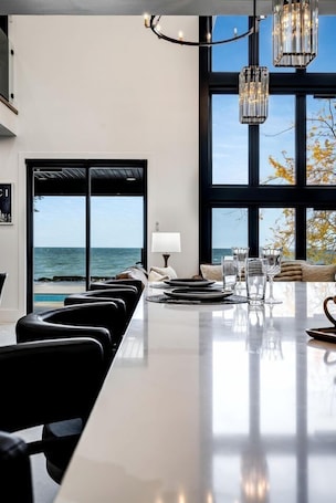 Dining. Sophisticated Shoreline Retreat with Sunset Patio & Poolside Lounging in Ontario, Canada