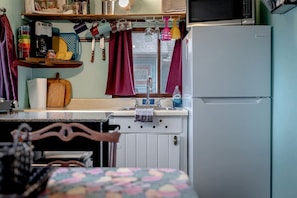 A compact kitchen with a refrigerator, a sink, and a microwave. - Cozy Lake Tiny House Incredible to Create New Memories in Ontario (Leamington)