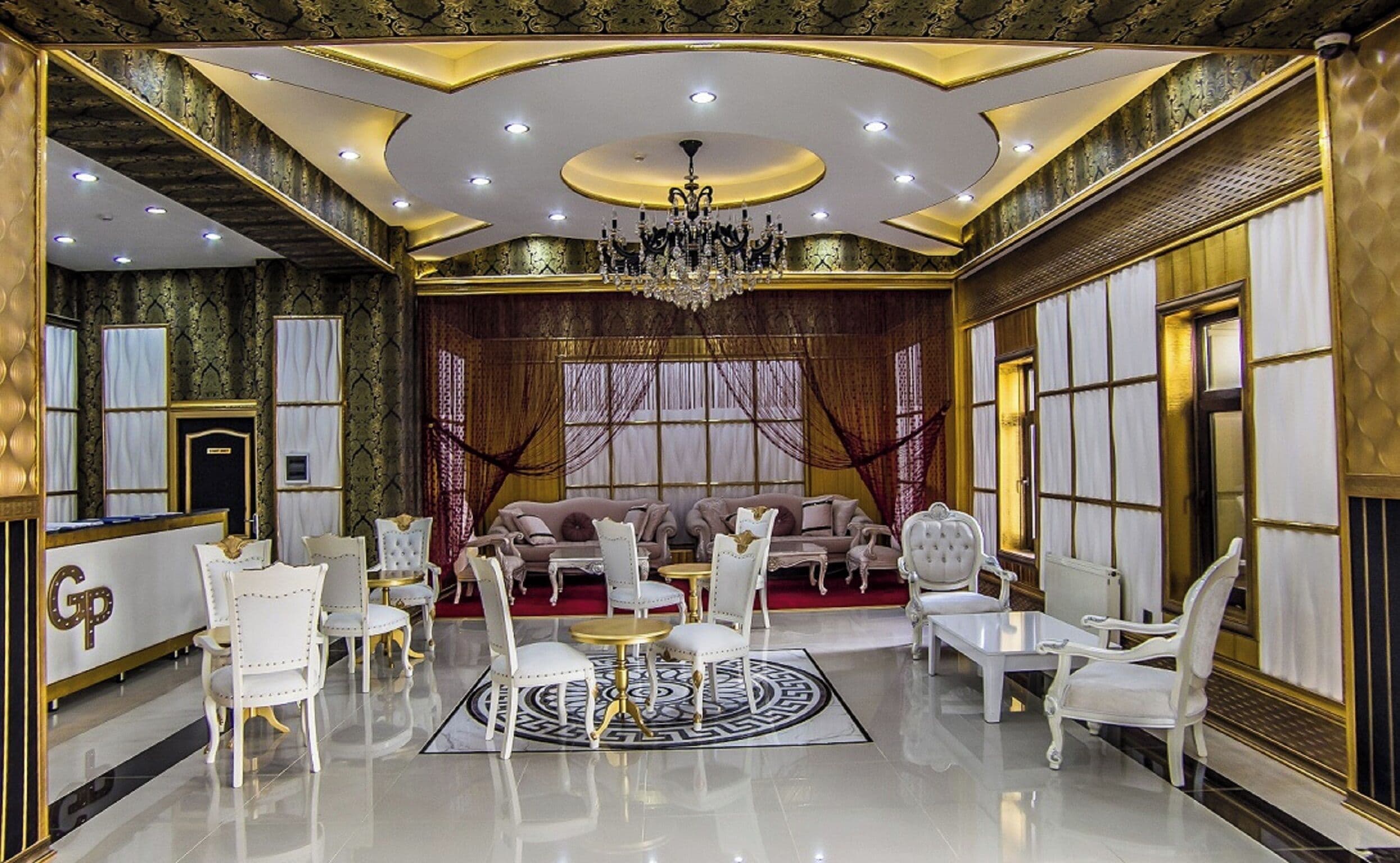 A luxurious room with a chandelier, elegant furniture, and a patterned floor.