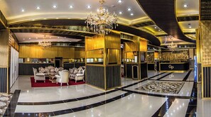 A luxurious lobby with a grand chandelier, plush seating, and a polished floor. - Amazon Hotel - Free Massage, Breakfast, & Dinner Included (Baku)