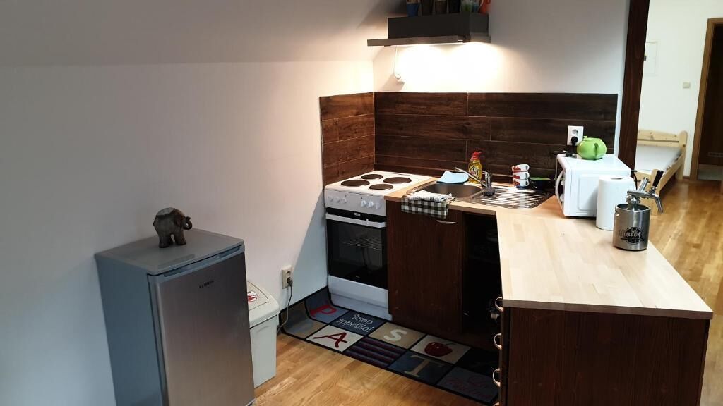 A compact kitchen with a stove, oven, and a refrigerator.