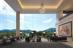 A spacious lounge with large windows, a chandelier, and a painting on the wall. - TAOYA Aso (Kain Minamiaso-mura,Aso-gun)