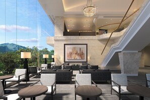 A modern hotel lobby with a large painting, multiple seating areas, and a staircase. - TAOYA Aso (Kain Minamiaso-mura,Aso-gun)