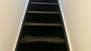 A narrow stairway with white walls and dark steps leading to a landing. - Sleek Studio in the Heart of the City (Ghent)