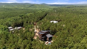A remote cabin surrounded by dense forest, with a clear view of the surrounding landscape. - Luxury Cabin with Heated Pool, Sauna & Hot Tub Retreat in Broken Bow, Oklahoma (Broken Bow)